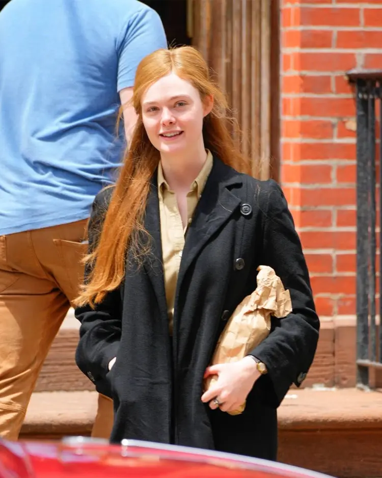 A Complete Unknown Elle Fanning Black Trench Coat Daylight Front View