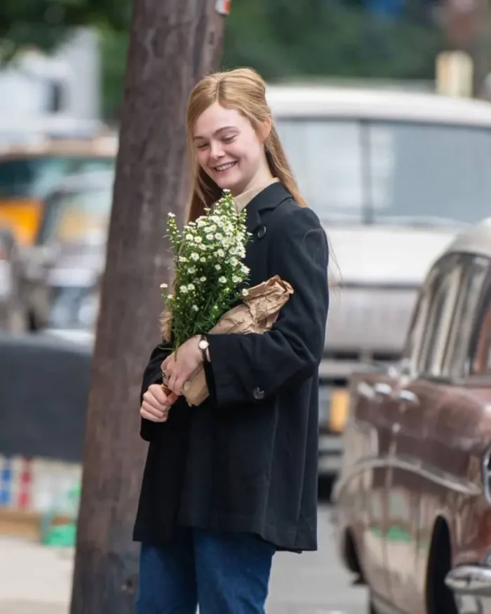 A Complete Unknown Elle Fanning Black Trench Coat Left Side Look